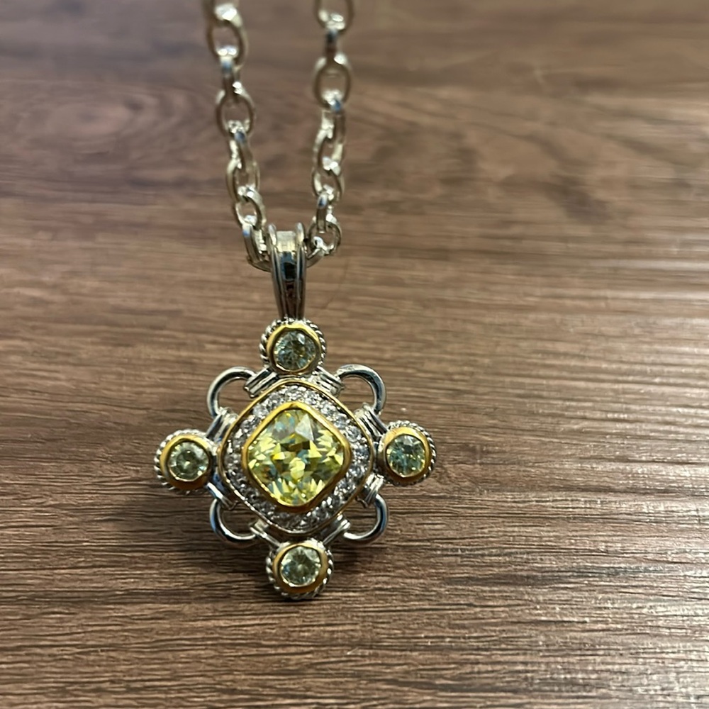 COPY - This sparkling piece is light green and clear stone set in gold and silv…